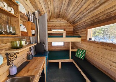 Vue complète de l'intérieur de Le Poulailler avec lits superposés et cuisinette en hiver